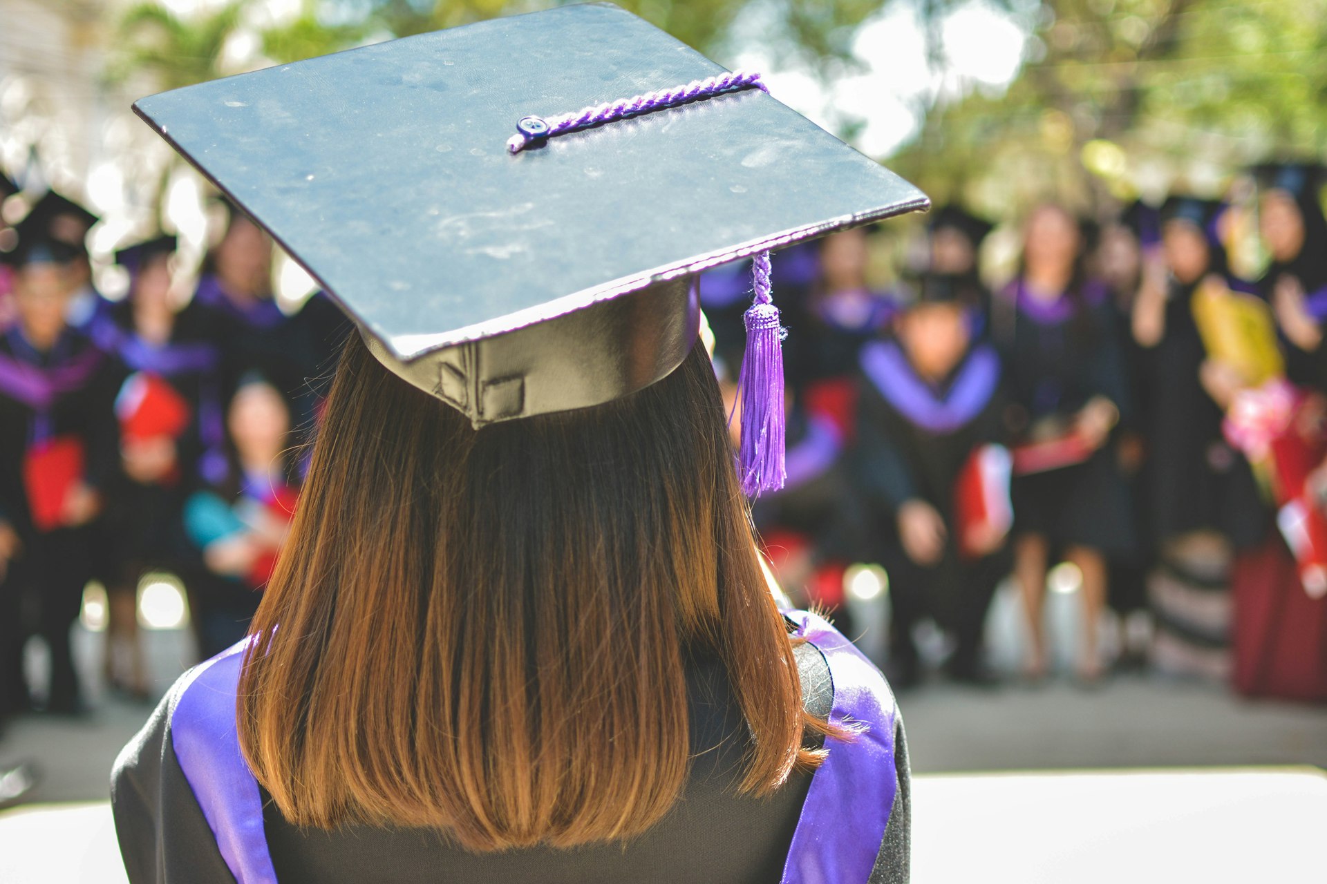 woman wearing academic cap and dress selective focus photography